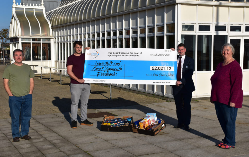 Sam Porter from Lowestoft Foodbank being presented with the cheque by East Coast College CEO Stuart Rimmer, along with foodbank volunteers.