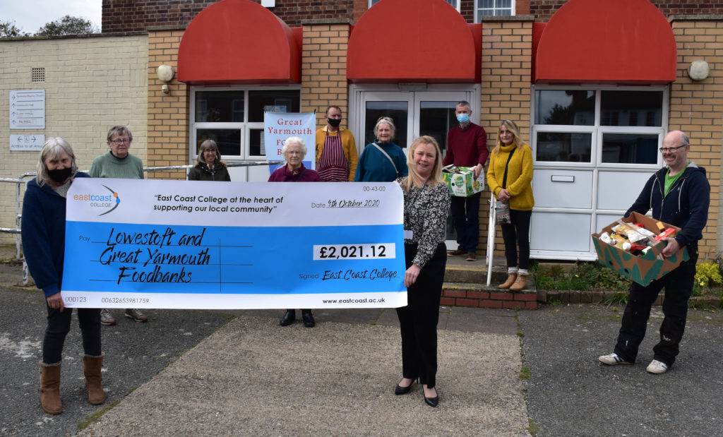 Liz Townson from Great Yarmouth Foodbank being presented with the cheque by East Coast College Assistant Principal Holly Chase,
 along with foodbank volunteers.